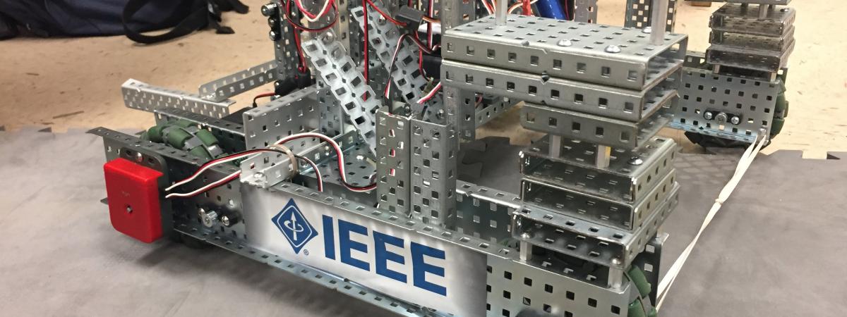 Robot on the floor with the IEEE logo on the side.